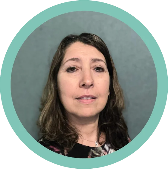 A head shot of a woman with olive toned skin and shoulder length dark wavy hair.